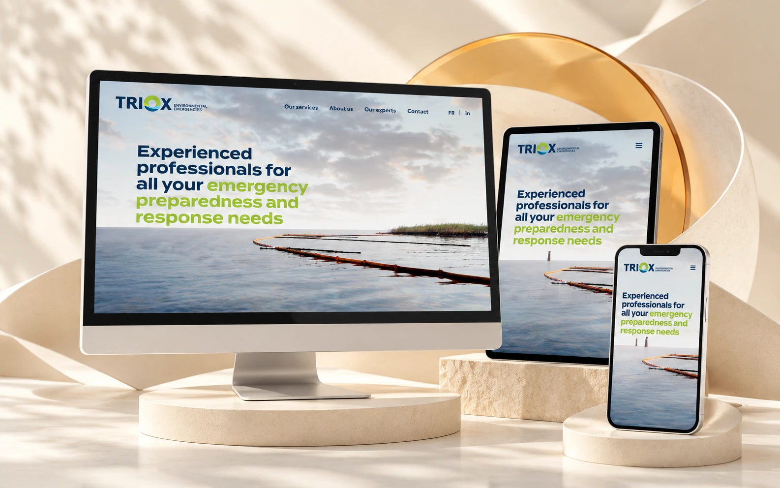 TRIOX website on desktop, tablet and phone, in a light setting with paper curves and an amber lens